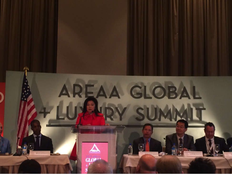 Above and Below: 2015 AREAA Chairwoman moderates a panel of experts on the state of international investment during the Global + Luxury Summit.
